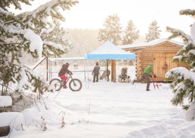 Photo of snowy day with bike kicksled and tent.